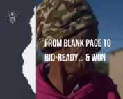 Elderly woman in a camouflage hat and pink fleece standing outdoors in a rural Northern Cape community under a clear blue sky